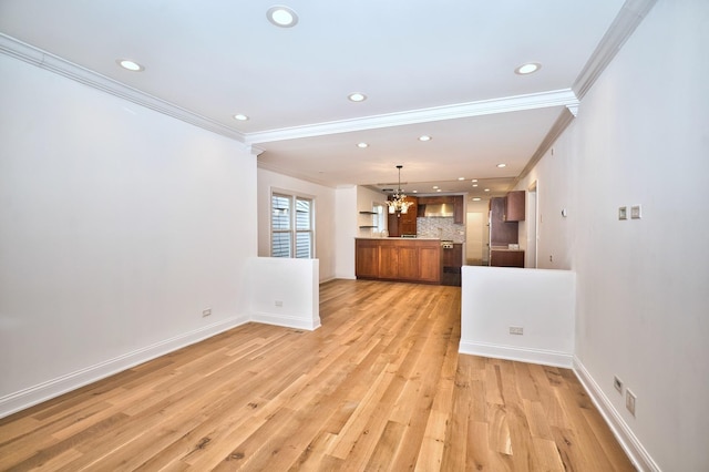 kitchen with brown cabinets, a notable chandelier, backsplash, light wood-style floors, and baseboards