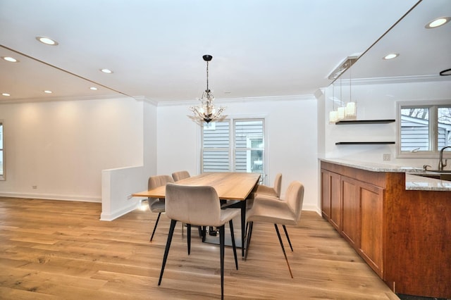 dining room featuring an inviting chandelier, recessed lighting, light wood-type flooring, and ornamental molding