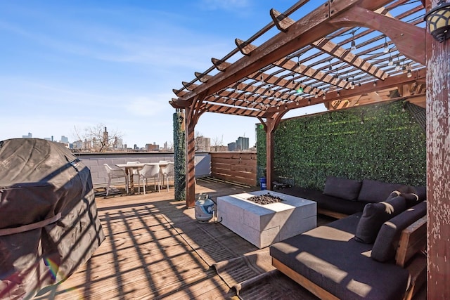 view of patio featuring a deck, outdoor dining area, area for grilling, a pergola, and an outdoor living space with a fire pit