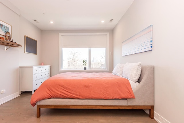 bedroom featuring baseboards, visible vents, wood finished floors, and recessed lighting