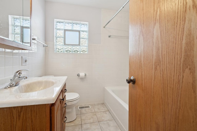 full bath featuring visible vents, toilet, tile patterned flooring, vanity, and tile walls