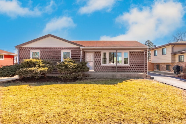 ranch-style house with brick siding and a front lawn