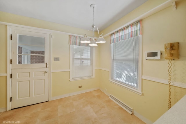 unfurnished dining area featuring an inviting chandelier and baseboards