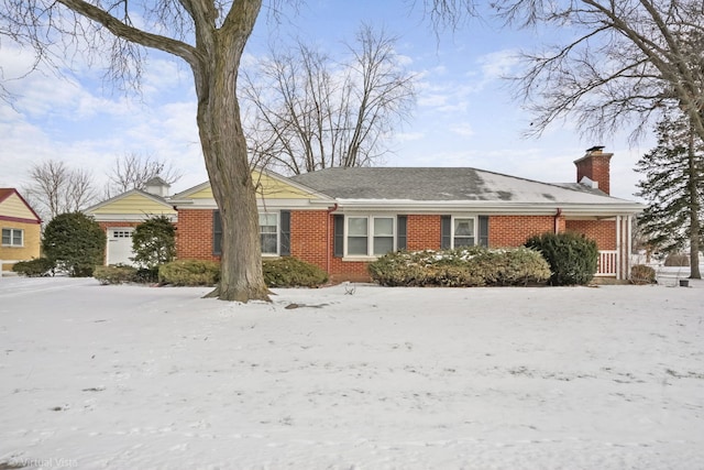 single story home with brick siding and a chimney