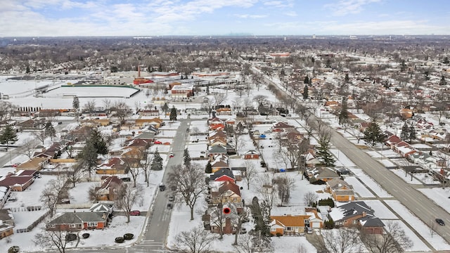 snowy aerial view featuring a residential view