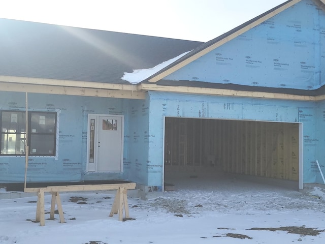 view of snow covered garage