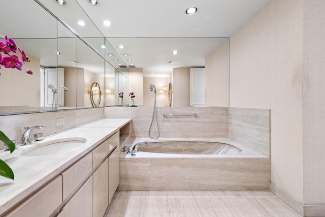 bathroom featuring a shower, recessed lighting, vanity, and a bath