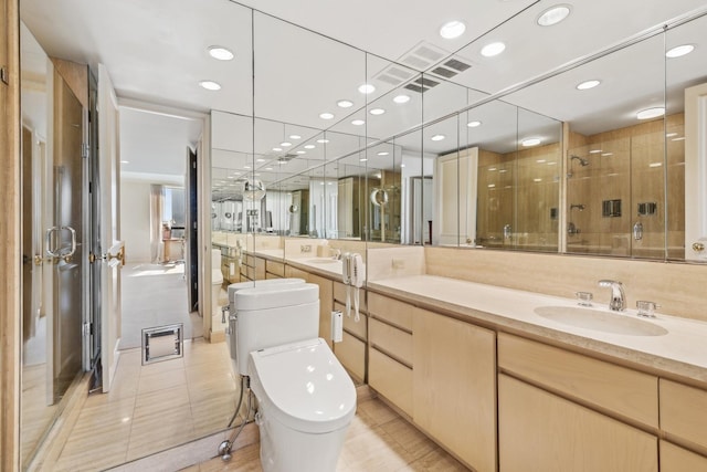 bathroom featuring toilet, tile patterned flooring, vanity, and a shower with shower door