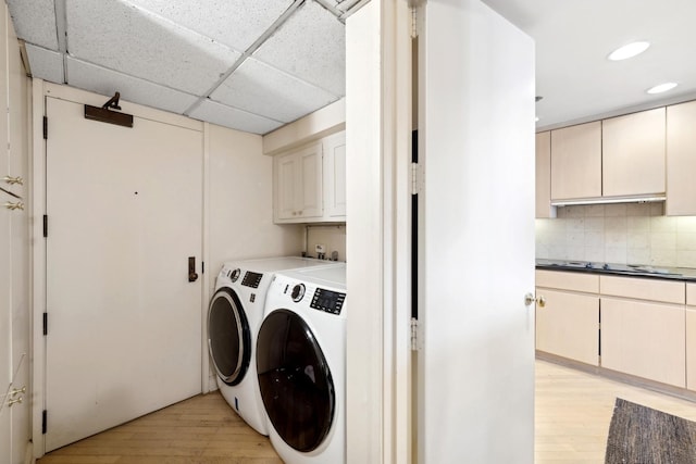 laundry room featuring separate washer and dryer, light wood-type flooring, cabinet space, and recessed lighting