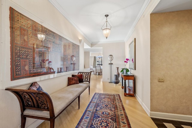 hallway featuring crown molding, baseboards, and wood finished floors