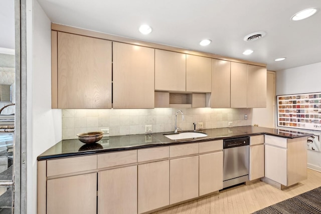 kitchen featuring a sink, dark countertops, visible vents, and stainless steel dishwasher