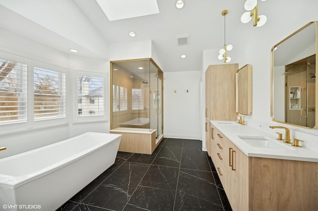full bathroom with a stall shower, a skylight, visible vents, and a sink