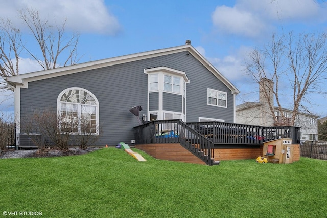 rear view of house with stairs, a yard, and a wooden deck
