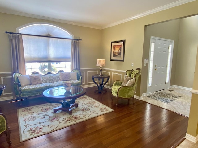 living room with hardwood / wood-style flooring and crown molding