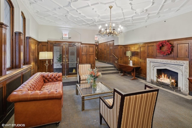 carpeted living room featuring a fireplace and an inviting chandelier