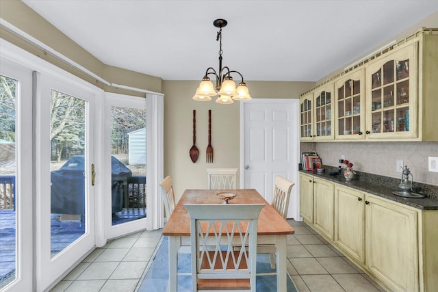 dining space featuring light tile patterned floors and a chandelier