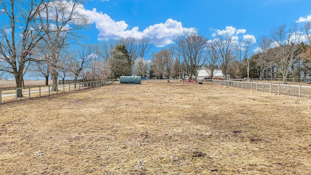 view of yard with a rural view and fence