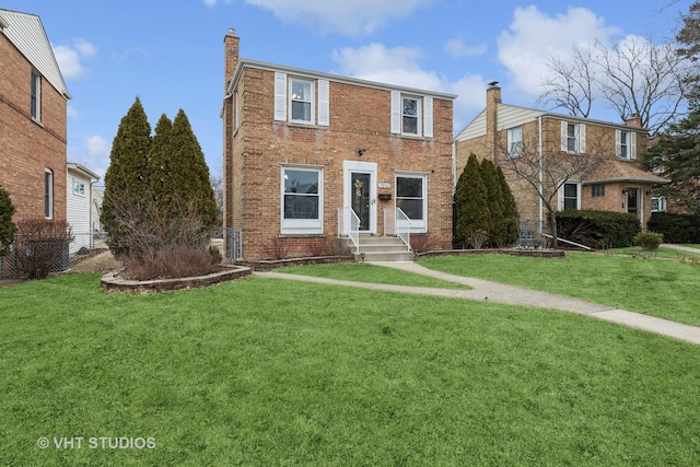 view of front of house featuring a chimney, fence, a front lawn, and brick siding