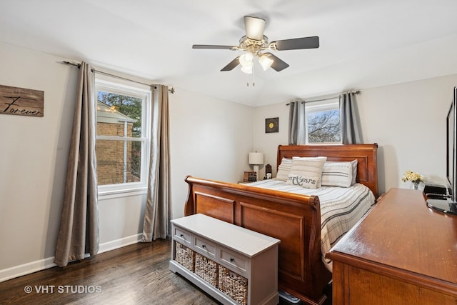 bedroom featuring vaulted ceiling, multiple windows, dark wood finished floors, and baseboards