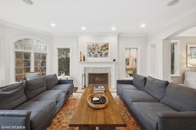 living area with ornamental molding, recessed lighting, and a fireplace