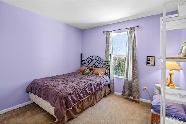 bedroom with carpet and multiple windows