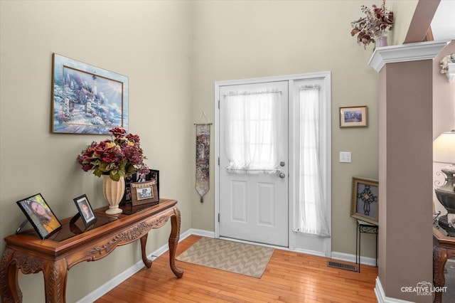 foyer entrance with light hardwood / wood-style floors