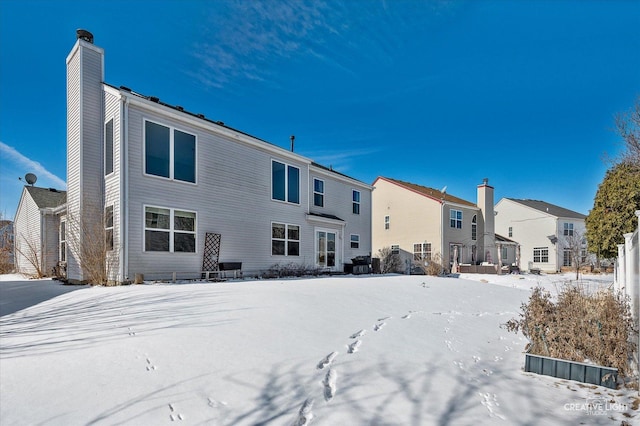 view of snow covered rear of property