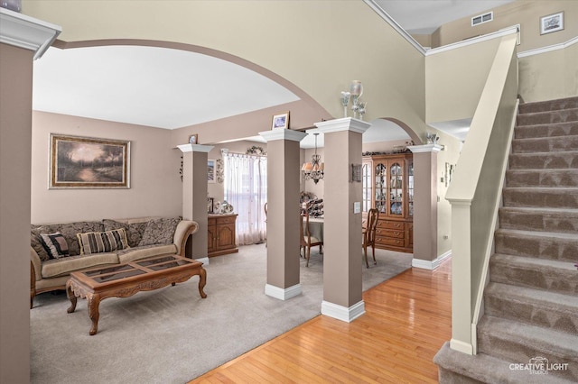 living room with light hardwood / wood-style flooring and decorative columns