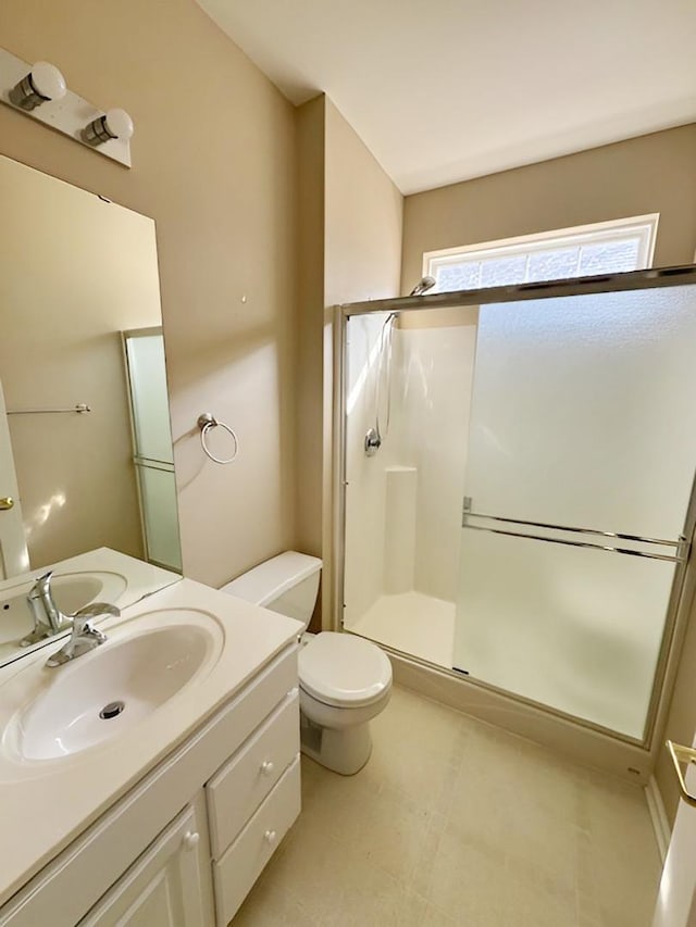 bathroom featuring vanity, an enclosed shower, and toilet