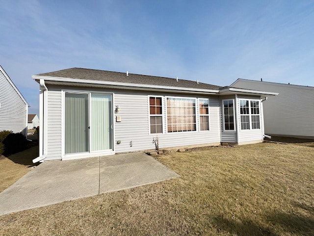 rear view of house with a yard and a patio area