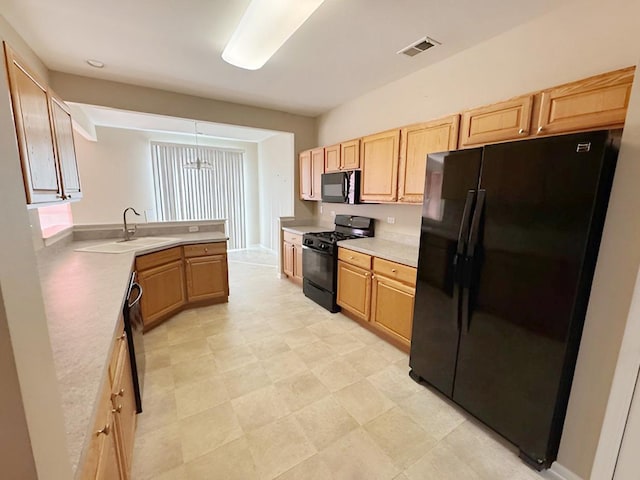 kitchen with sink, black appliances, and light brown cabinets