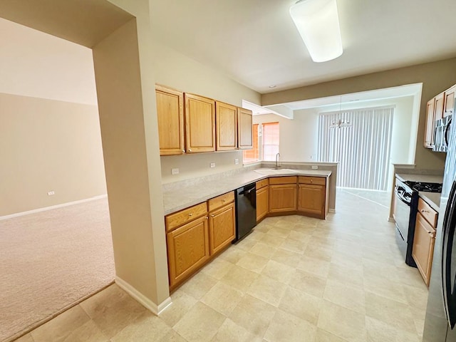 kitchen featuring black appliances, kitchen peninsula, pendant lighting, sink, and light colored carpet