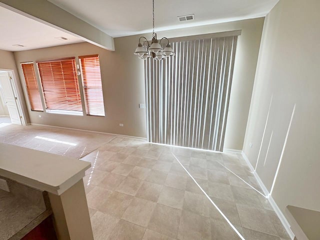 unfurnished dining area featuring beam ceiling and a chandelier