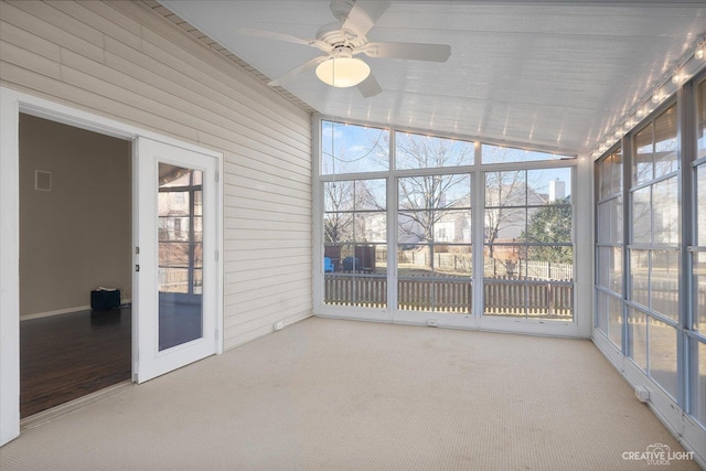 unfurnished sunroom featuring ceiling fan and vaulted ceiling