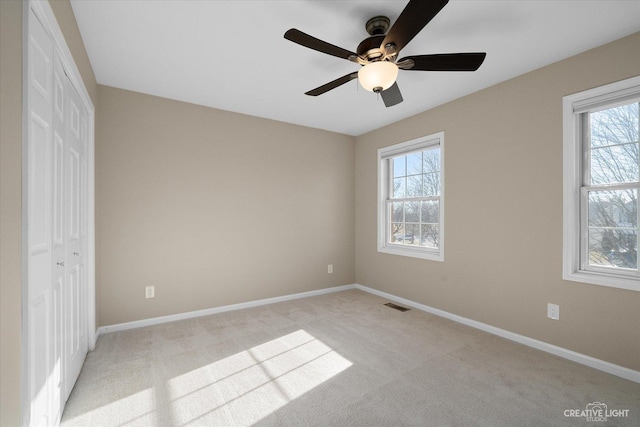 unfurnished bedroom with a closet, visible vents, and baseboards