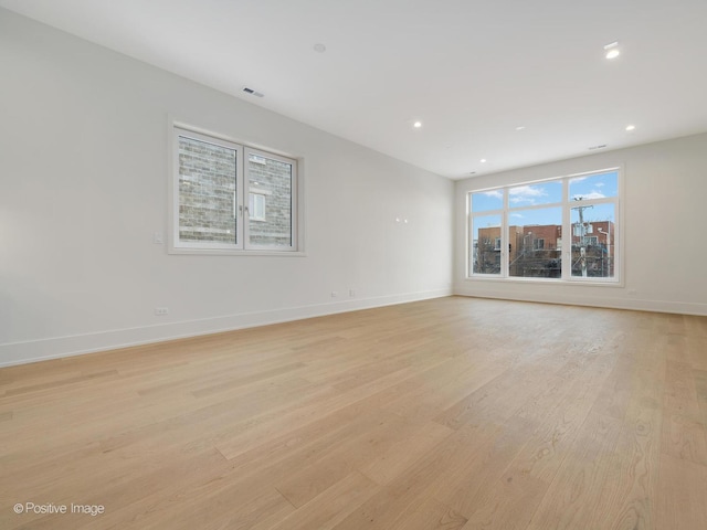 spare room featuring light wood-type flooring