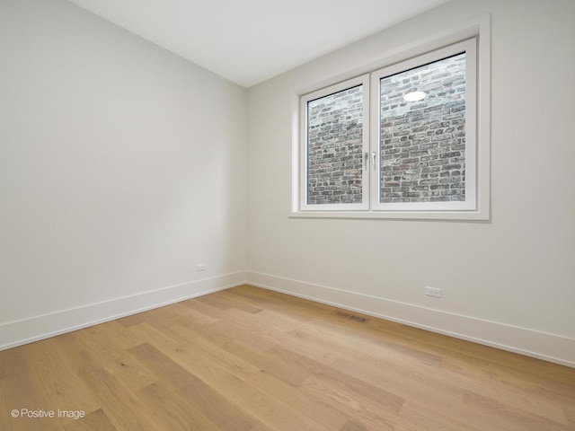 spare room with light hardwood / wood-style floors