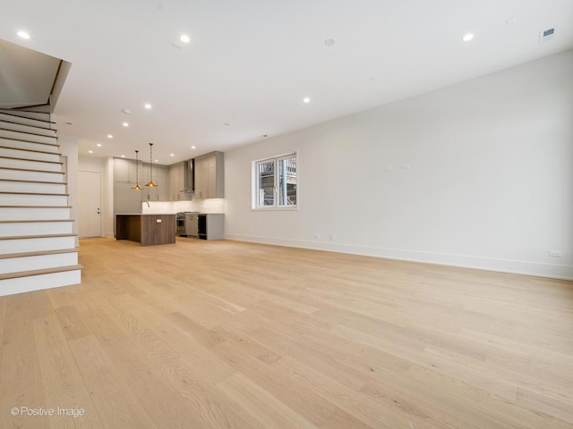 unfurnished living room featuring light hardwood / wood-style flooring