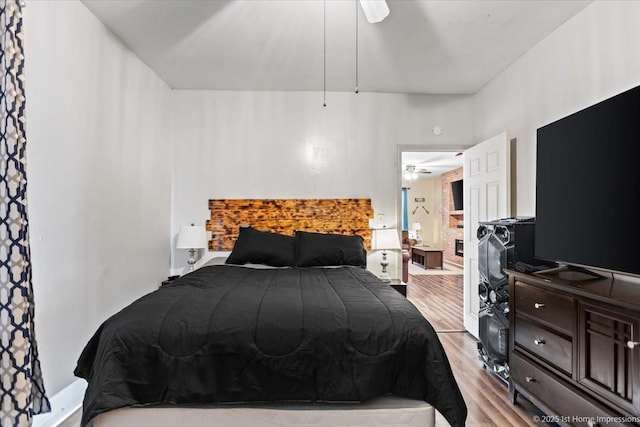 bedroom featuring light wood finished floors and baseboards