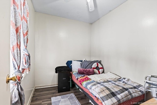 bedroom featuring ceiling fan, dark wood-type flooring, and baseboards