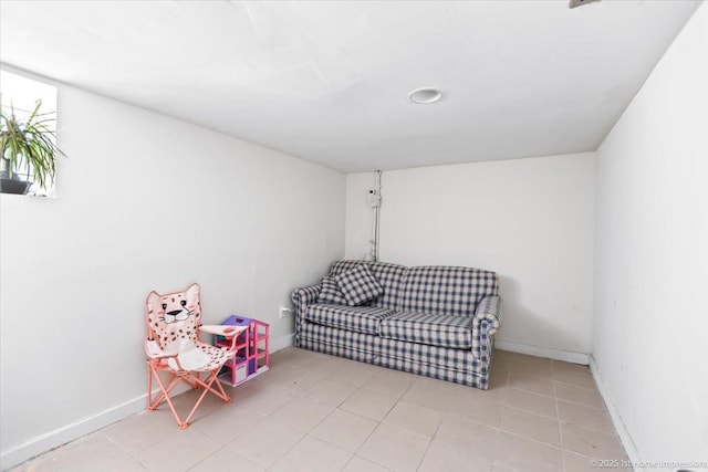 living area with light tile patterned floors and baseboards