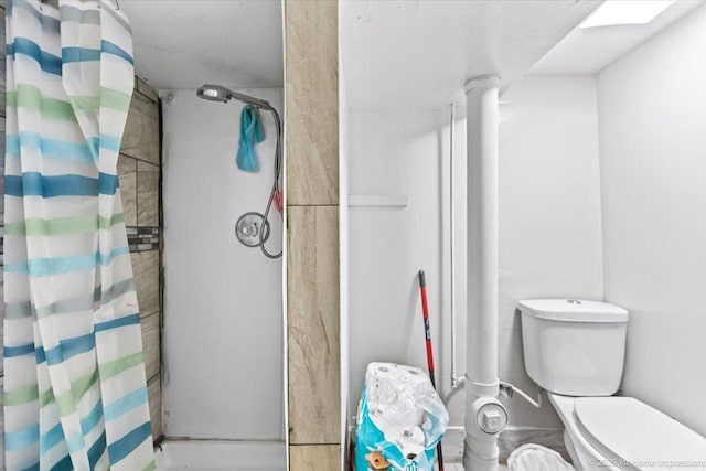 bathroom featuring a stall shower and toilet