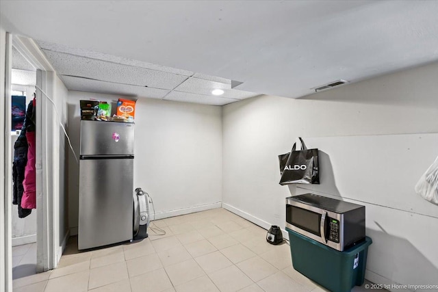 miscellaneous room featuring a paneled ceiling, visible vents, and baseboards