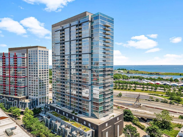 view of building exterior with a view of city and a water view