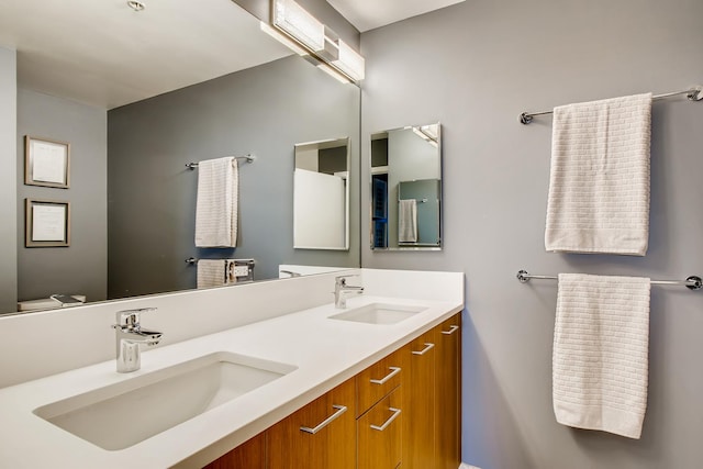 full bathroom with double vanity and a sink