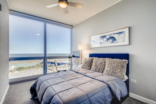 carpeted bedroom featuring floor to ceiling windows, a ceiling fan, and baseboards