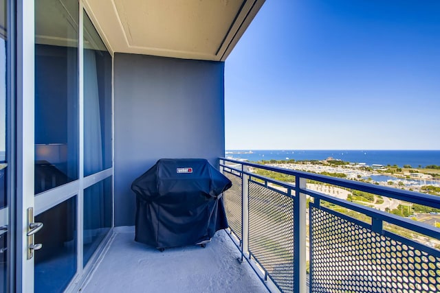 balcony with area for grilling and a water view