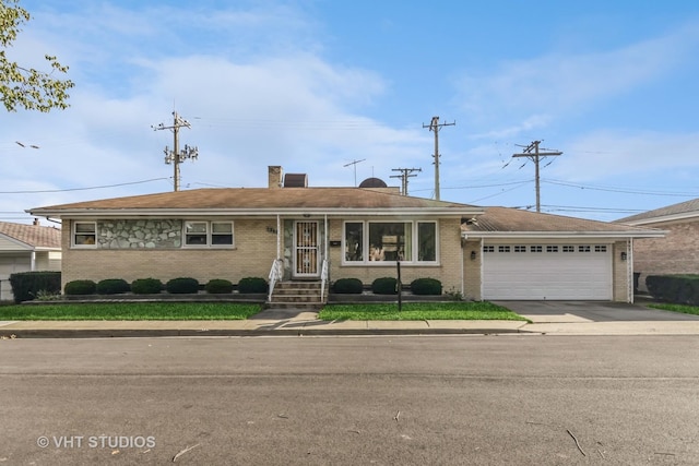 ranch-style house with a garage, concrete driveway, brick siding, and a chimney