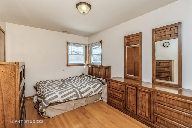 bedroom featuring visible vents and light wood finished floors