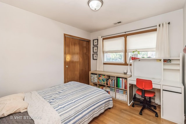 bedroom featuring a closet and wood finished floors